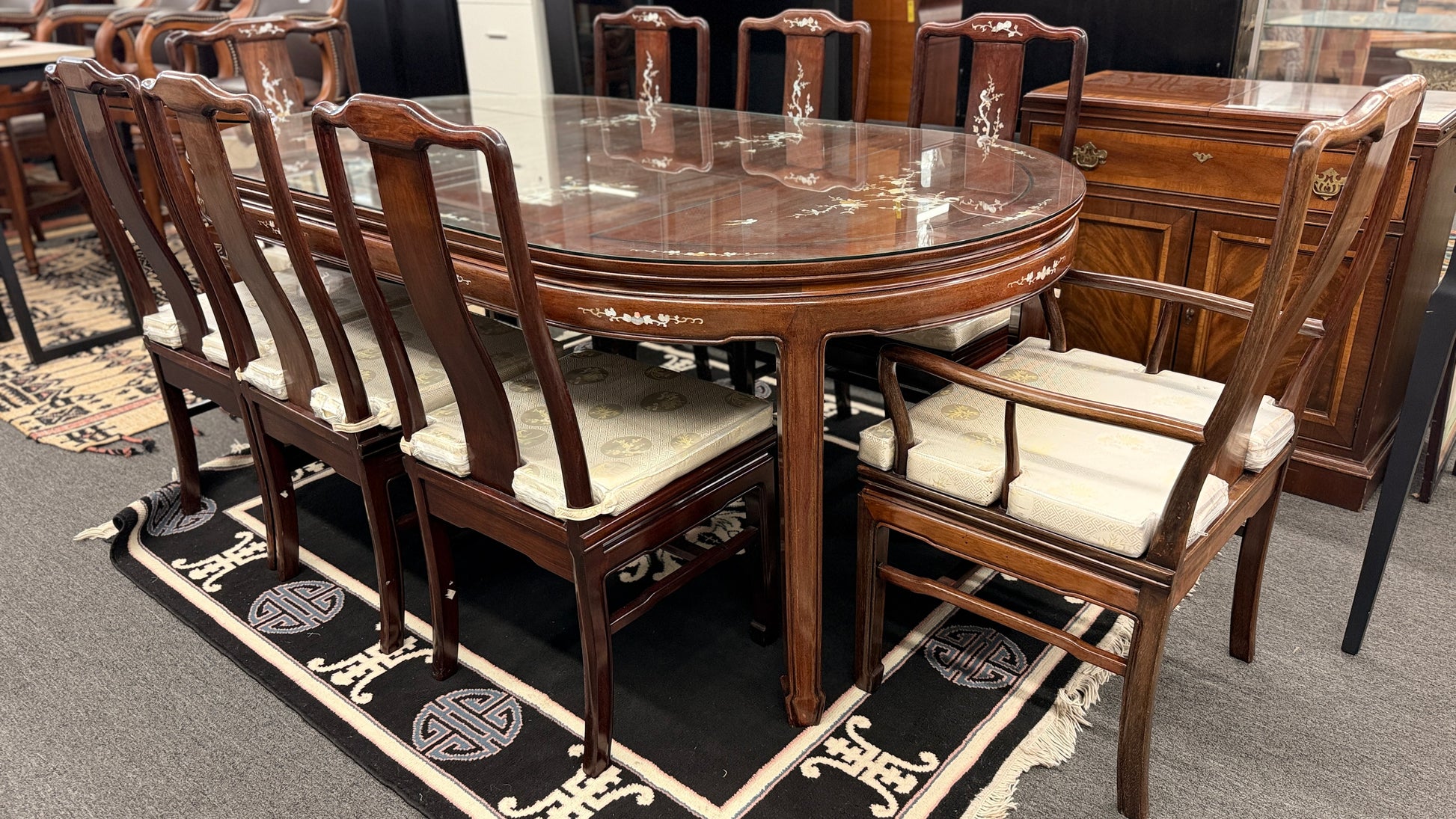 Chinoiserie inlaid wood 9pc oval dining set featuring a glass top table and mother of pearl detail at 2nd Debut Houston consignment showroom