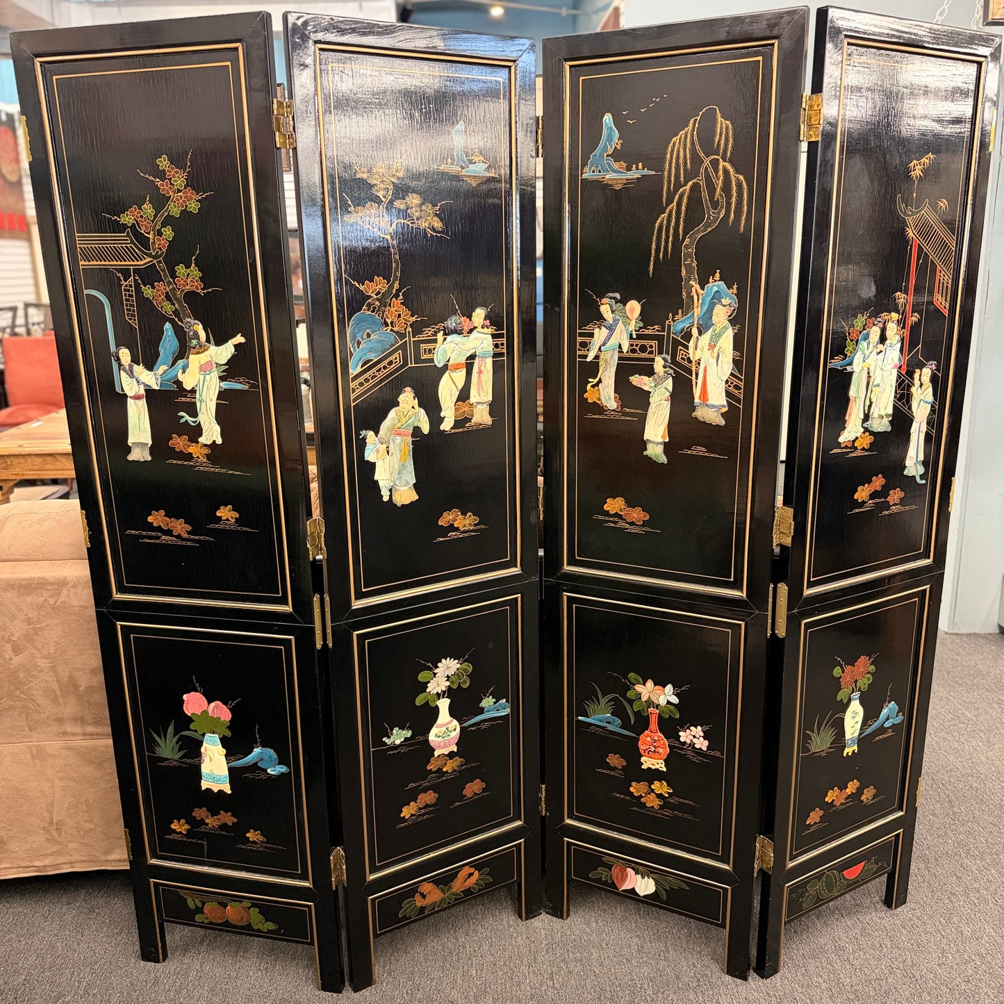 Traditional Chinoiserie multi panel wood folding room divider and privacy screen featuring intricate decorative designs on a carpeted floor at 2nd Debut Houston consignment showroom