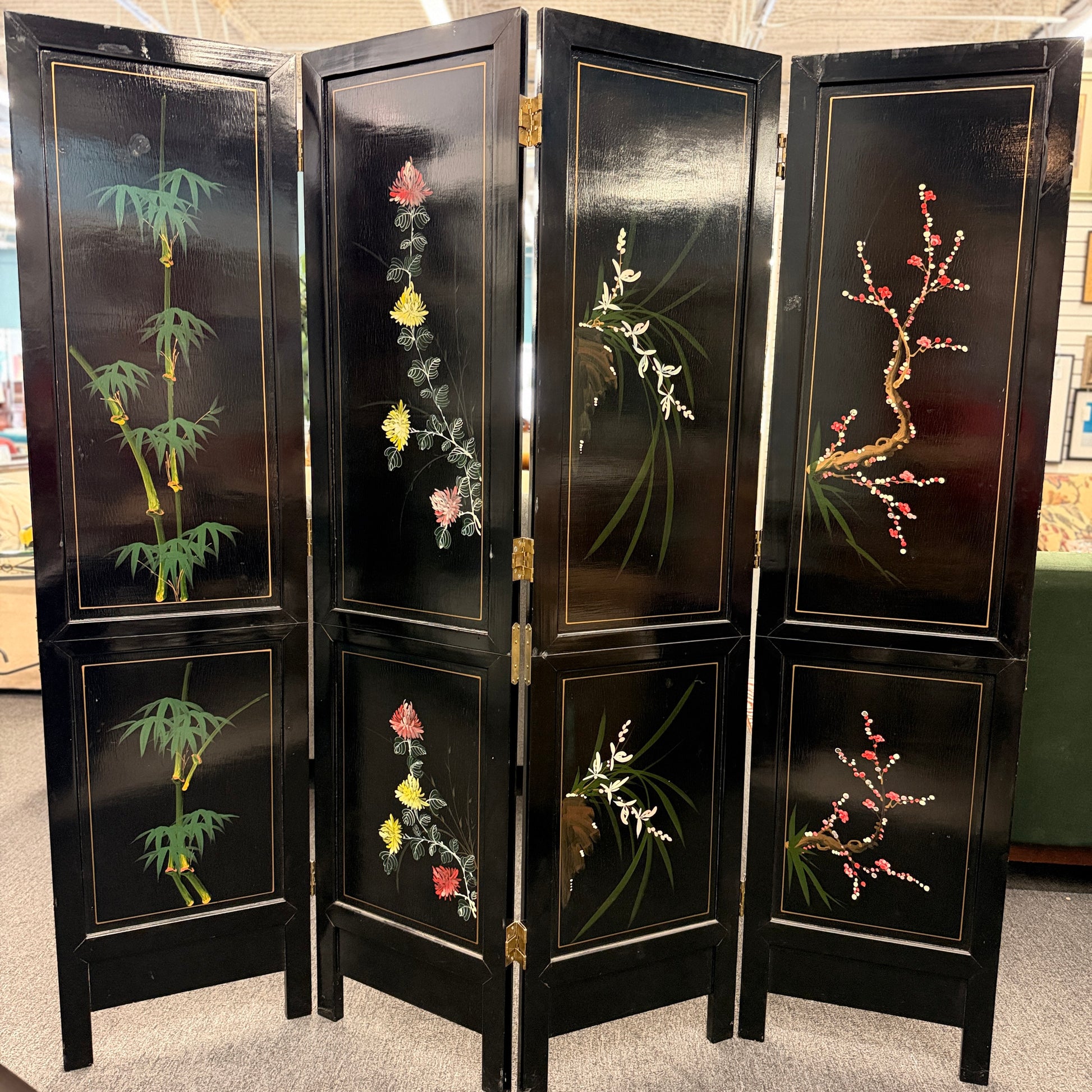 Traditional Chinoiserie multi panel wood folding room divider and privacy screen featuring intricate decorative designs on a carpeted floor at 2nd Debut Houston consignment showroom