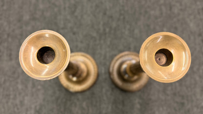A pair of classic fluted brass candlesticks standing 11 inches tall with round bases in excellent condition.