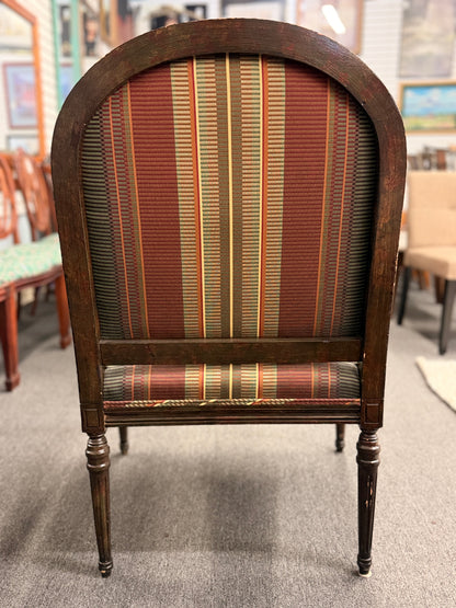 A classic French-style accent armchair with a dark wood frame, an oval medallion backrest, fluted straight legs, and traditional striped fabric upholstery.