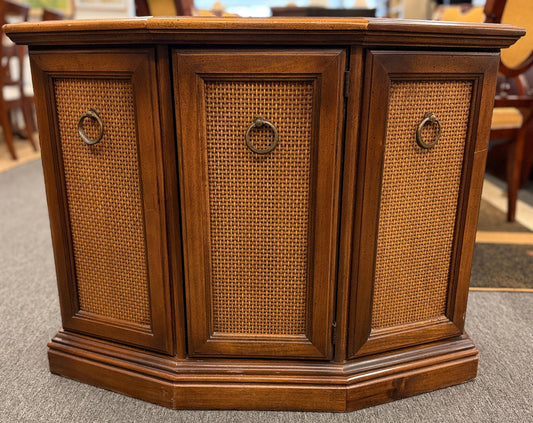 A classic wood accent cabinet featuring three front panels with decorative metal ring-pull hardware and a clean-lined wood frame.