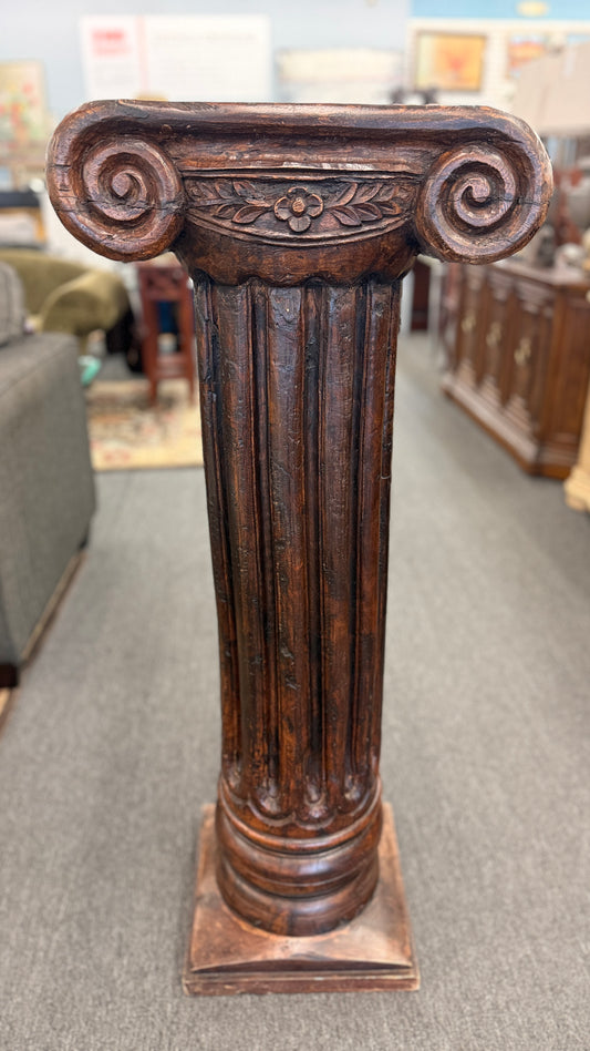 A classical wooden architectural pedestal featuring a carved Ionic scroll capital with floral motifs, a fluted shaft, and a square plinth base in excellent condition.