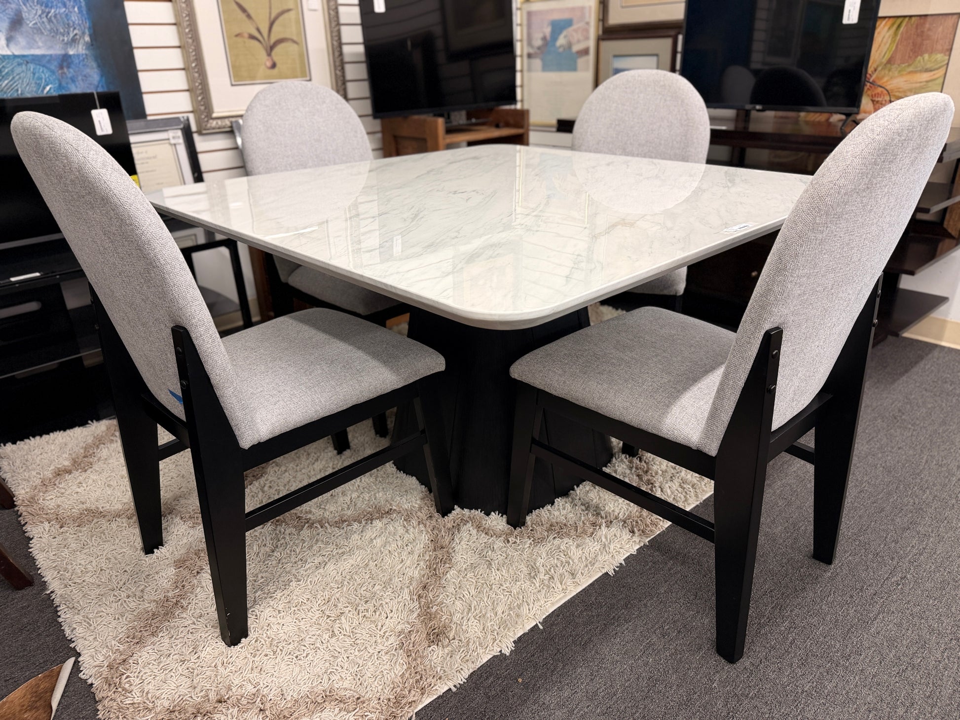 A contemporary 5-piece dining set featuring a square dining table with a glossy stone-look top and four tall upholstered matching chairs.