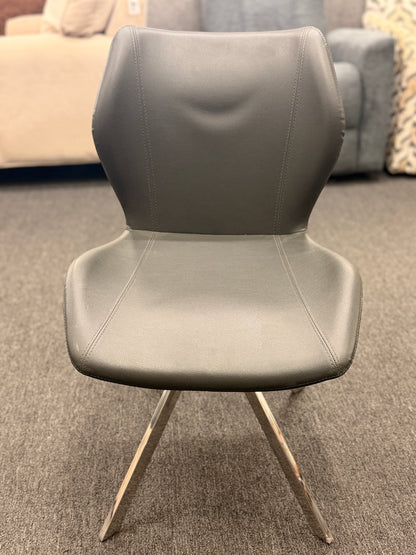 An accent office chair featuring sleek charcoal-gray faux leather upholstery with stitched seams, set on four angled chrome legs in good condition.