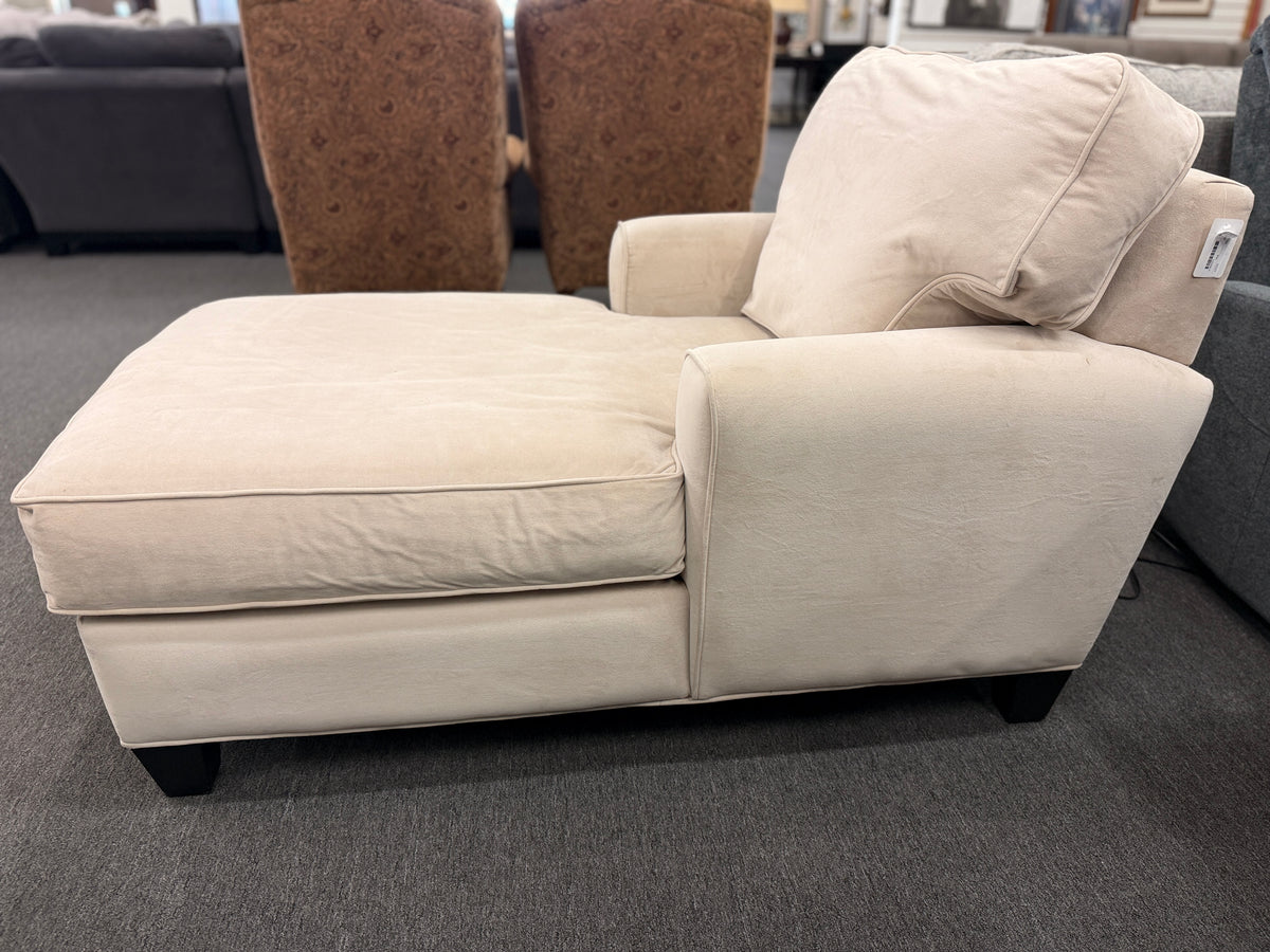 A contemporary single-seat chaise lounge upholstered in plush cream microfiber with track arms and a back cushion in good condition.
