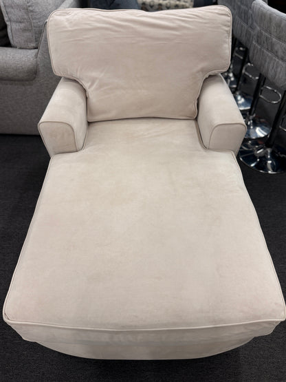 A contemporary single-seat chaise lounge upholstered in plush cream microfiber with track arms and a back cushion in good condition.