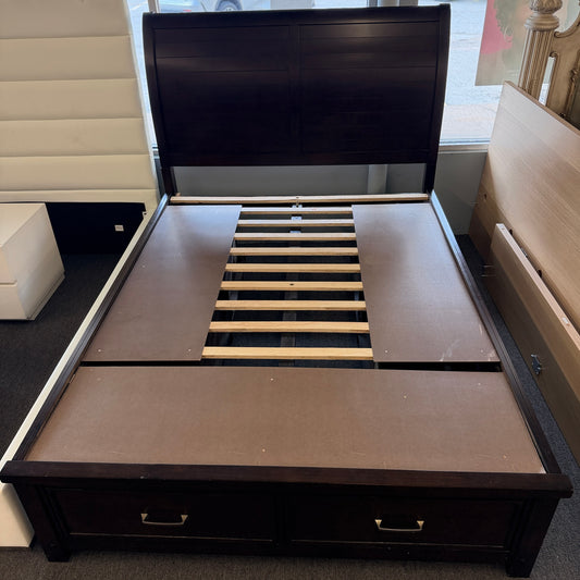 A contemporary dark-finished queen bed frame featuring a simple paneled headboard, wooden slat support, and two built-in storage drawers in the footboard.