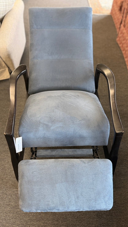 A contemporary high-back recliner upholstered in slate-blue textured fabric framed by slim contoured dark-wood armrests in excellent condition.