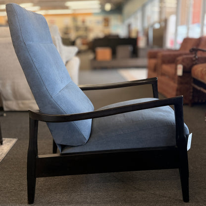 A contemporary high-back recliner upholstered in slate-blue textured fabric framed by slim contoured dark-wood armrests in excellent condition.