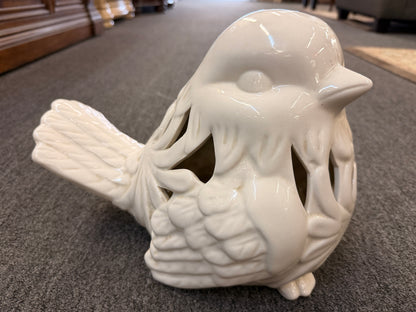 A cream glazed ceramic bird figurine featuring decorative openwork cutout hearts designed to hold a tealight or small candle in excellent condition.