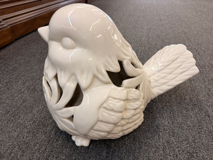 A cream glazed ceramic bird figurine featuring decorative openwork cutout hearts designed to hold a tealight or small candle in excellent condition.