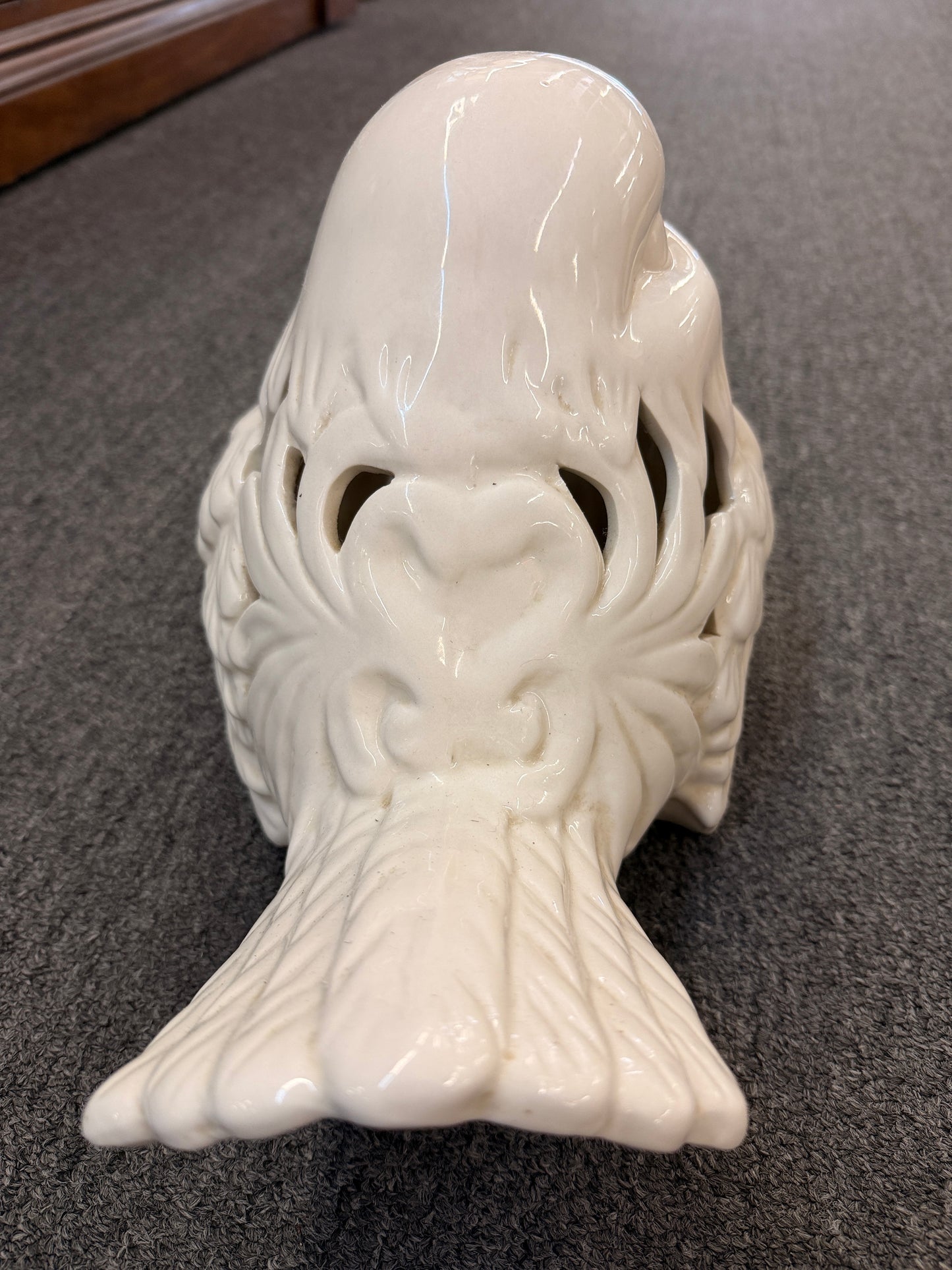 A cream glazed ceramic bird figurine featuring decorative openwork cutout hearts designed to hold a tealight or small candle in excellent condition.