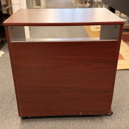 A compact mobile storage cabinet in a dark cherry finish featuring an open top shelf, double cabinet doors with curved black handles, and rolling wheels.