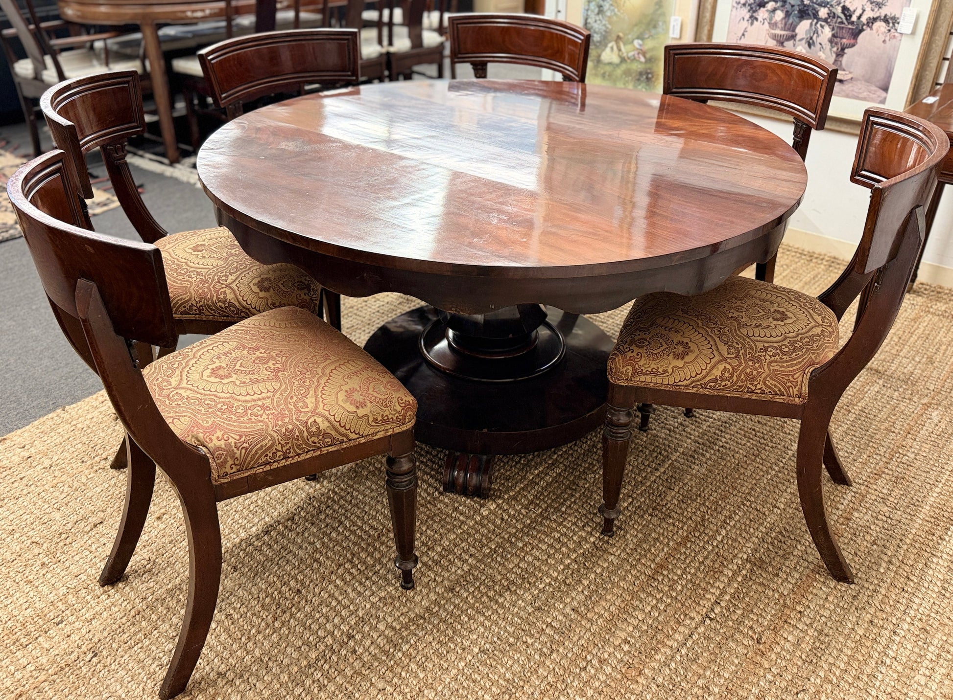 Traditional dark wood round pedestal dining set with 51 inch table and patterned fabric chairs at 2nd Debut Houston consignment showroom