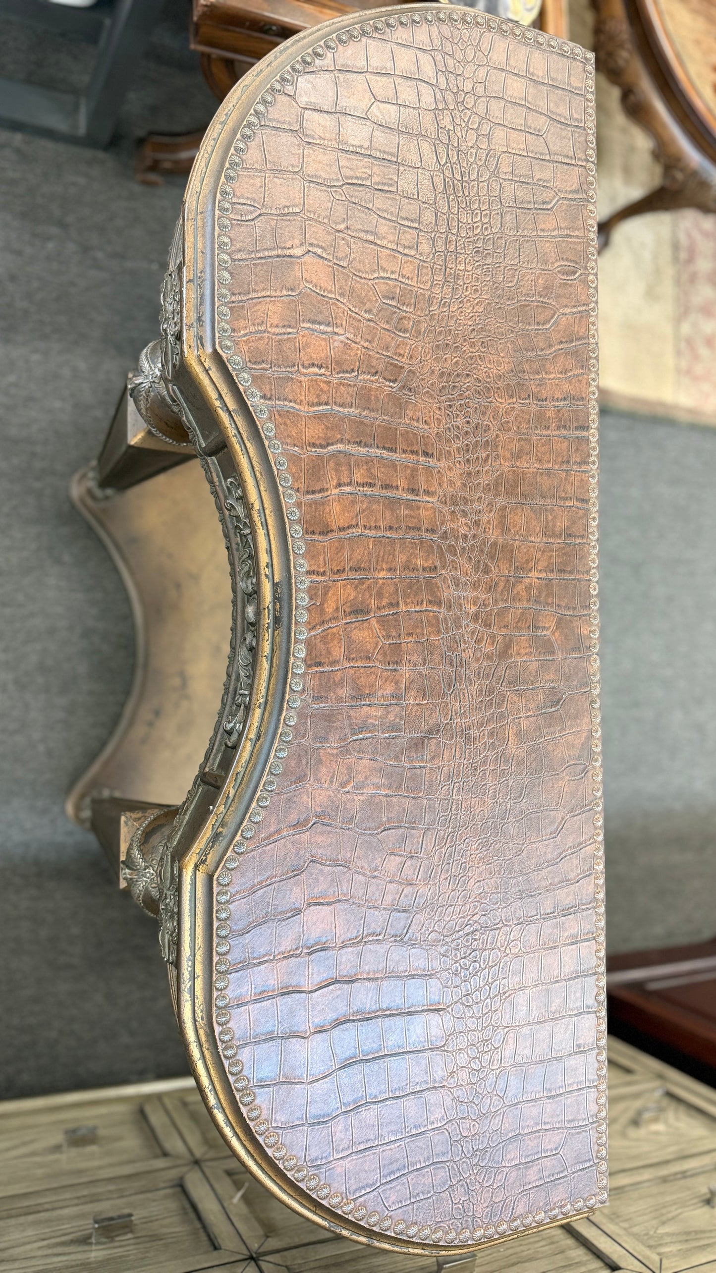 Distressed wood console table featuring ornate carved details, a center drawer, sculpted legs, and a gracefully curved lower stretcher.