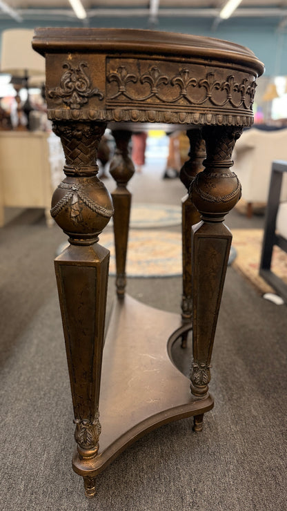 Distressed wood console table featuring ornate carved details, a center drawer, sculpted legs, and a gracefully curved lower stretcher.