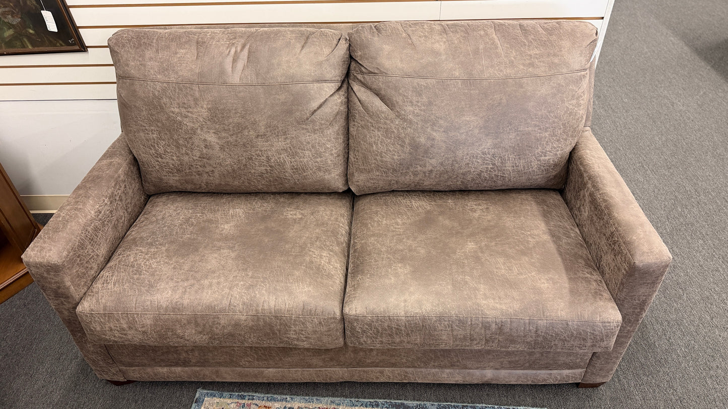 A plush two-seater sleeper sofa with pillow-top backrests and tapered track arms in textured distressed taupe-brown fabric.