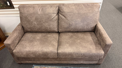 A plush two-seater sleeper sofa with pillow-top backrests and tapered track arms in textured distressed taupe-brown fabric.