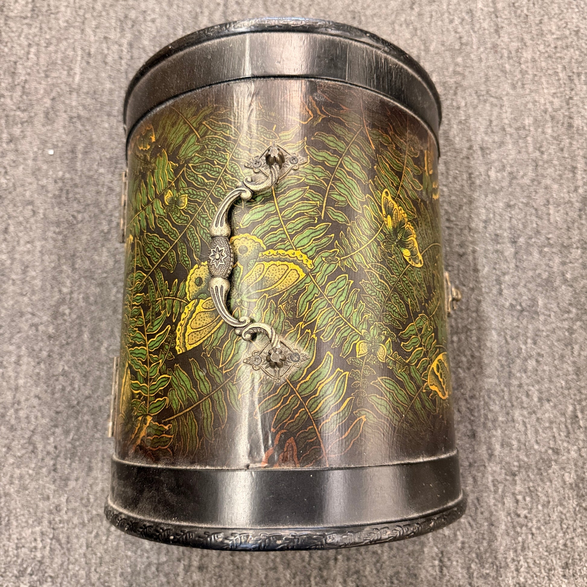 A small domed-top wooden treasure chest featuring green fern patterns, gold butterfly motifs, a metal swing clasp, and top handle in good condition.