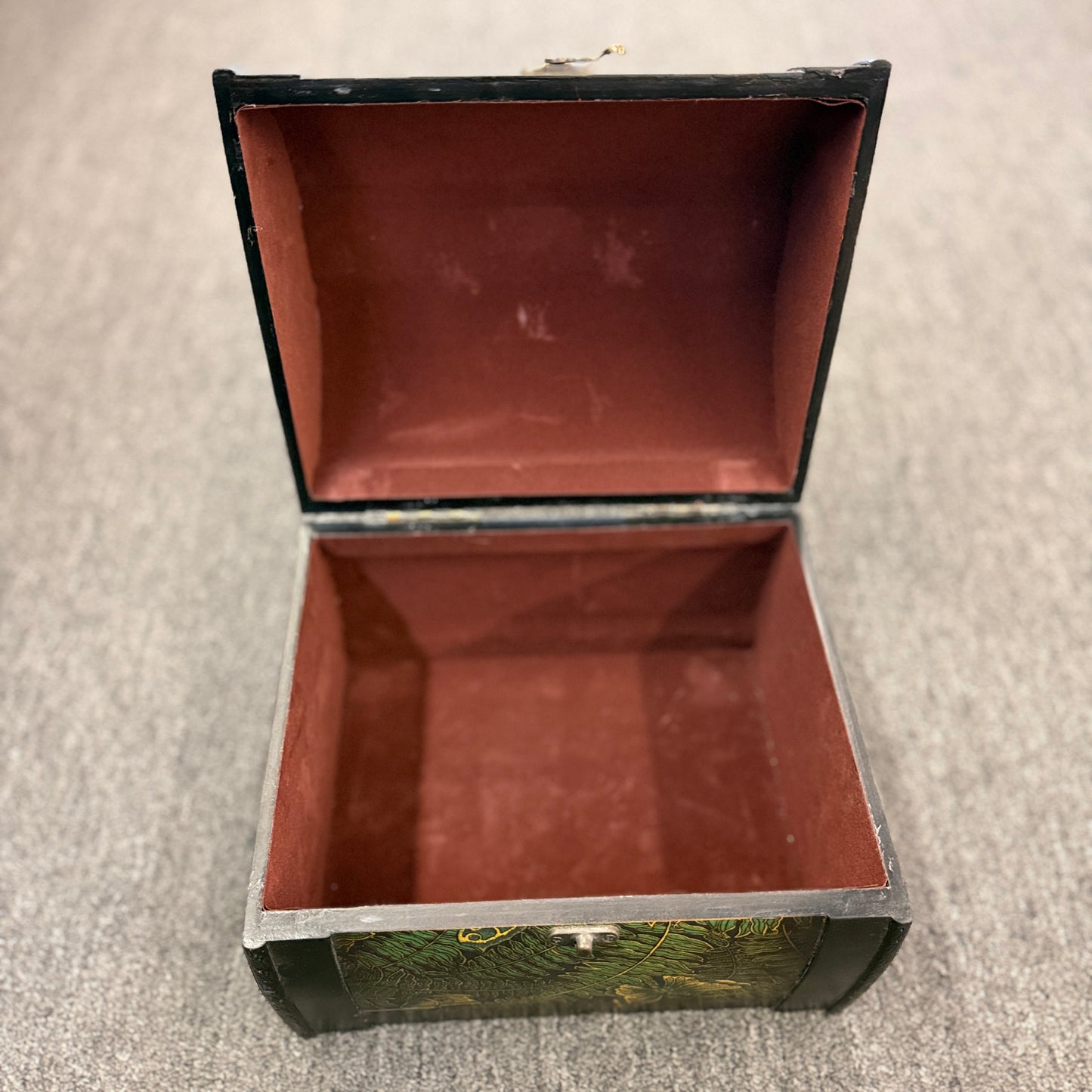 A small domed-top wooden treasure chest featuring green fern patterns, gold butterfly motifs, a metal swing clasp, and top handle in good condition.