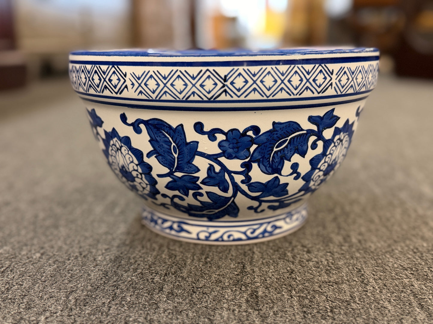 An elegant decorative oriental ceramic bowl resting on a flat surface in excellent condition.