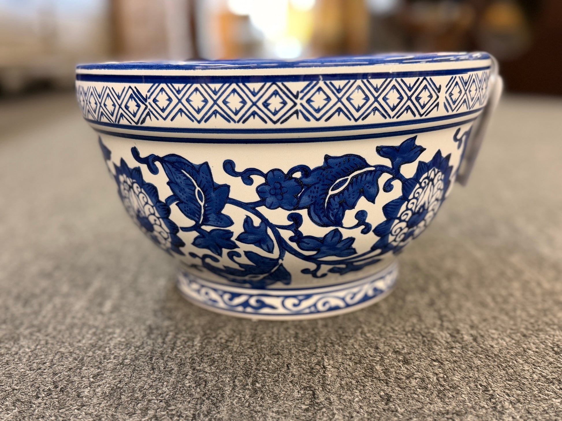 An elegant decorative oriental ceramic bowl resting on a flat surface in excellent condition.