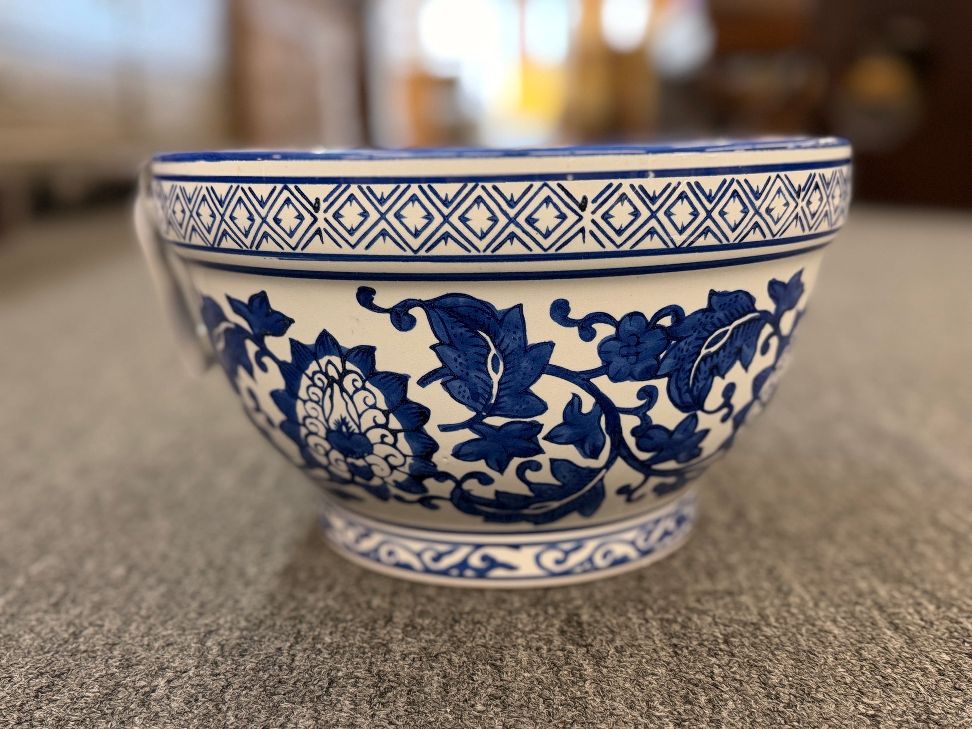 An elegant decorative oriental ceramic bowl resting on a flat surface in excellent condition.