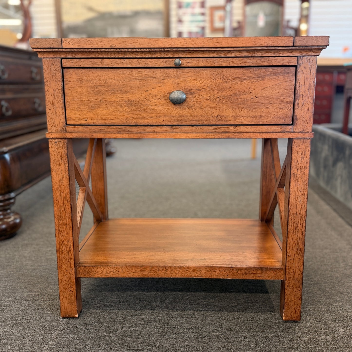 A traditional Ethan Allen wooden nightstand featuring a single top drawer, X-brace side panels, and an open lower shelf in good condition.