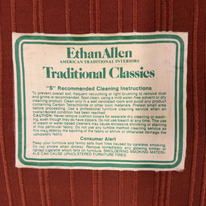 Ethan Allen upholstered armchair featuring rust-orange striped fabric, a button-tufted backrest, padded rolled arms, and a tailored skirted base.