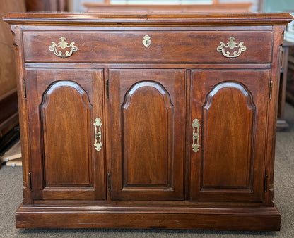 Traditional expandable wood buffet server and sideboard featuring three arched cabinet doors and brass handles at 2nd Debut Houston consignment showroom
