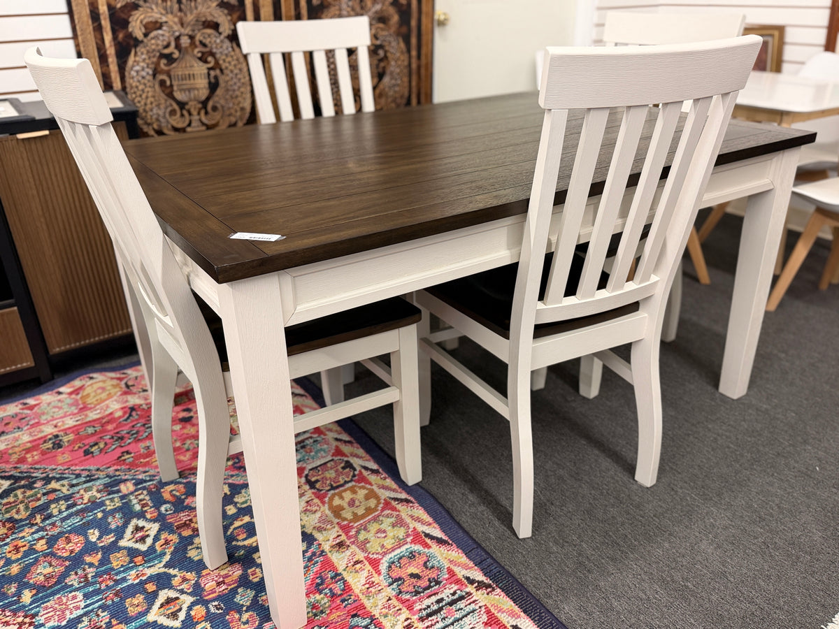 A farmhouse-style rectangular dining set with a dark-stained wood table top, antique white base, and four matching white slat-back chairs in excellent condition.
