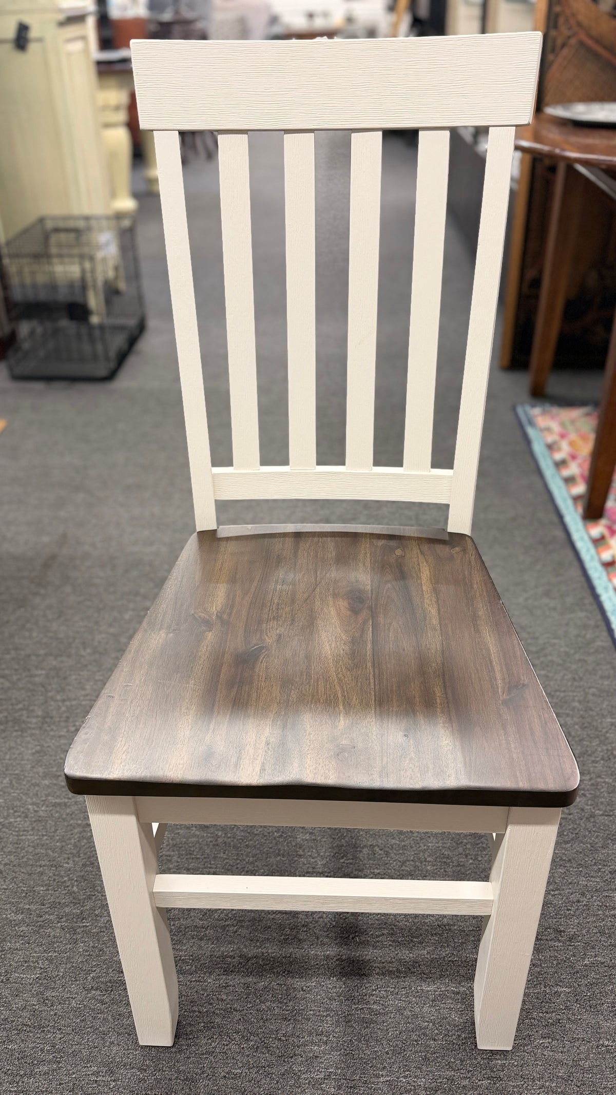A farmhouse-style rectangular dining set with a dark-stained wood table top, antique white base, and four matching white slat-back chairs in excellent condition.