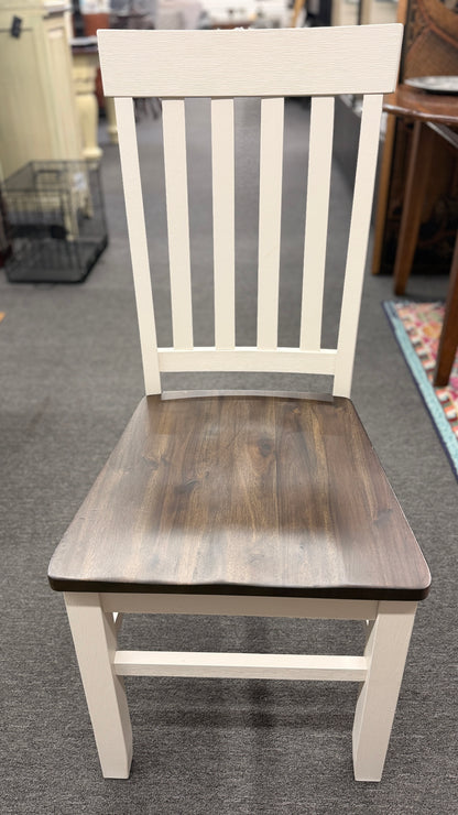 A farmhouse-style rectangular dining set with a dark-stained wood table top, antique white base, and four matching white slat-back chairs in excellent condition.