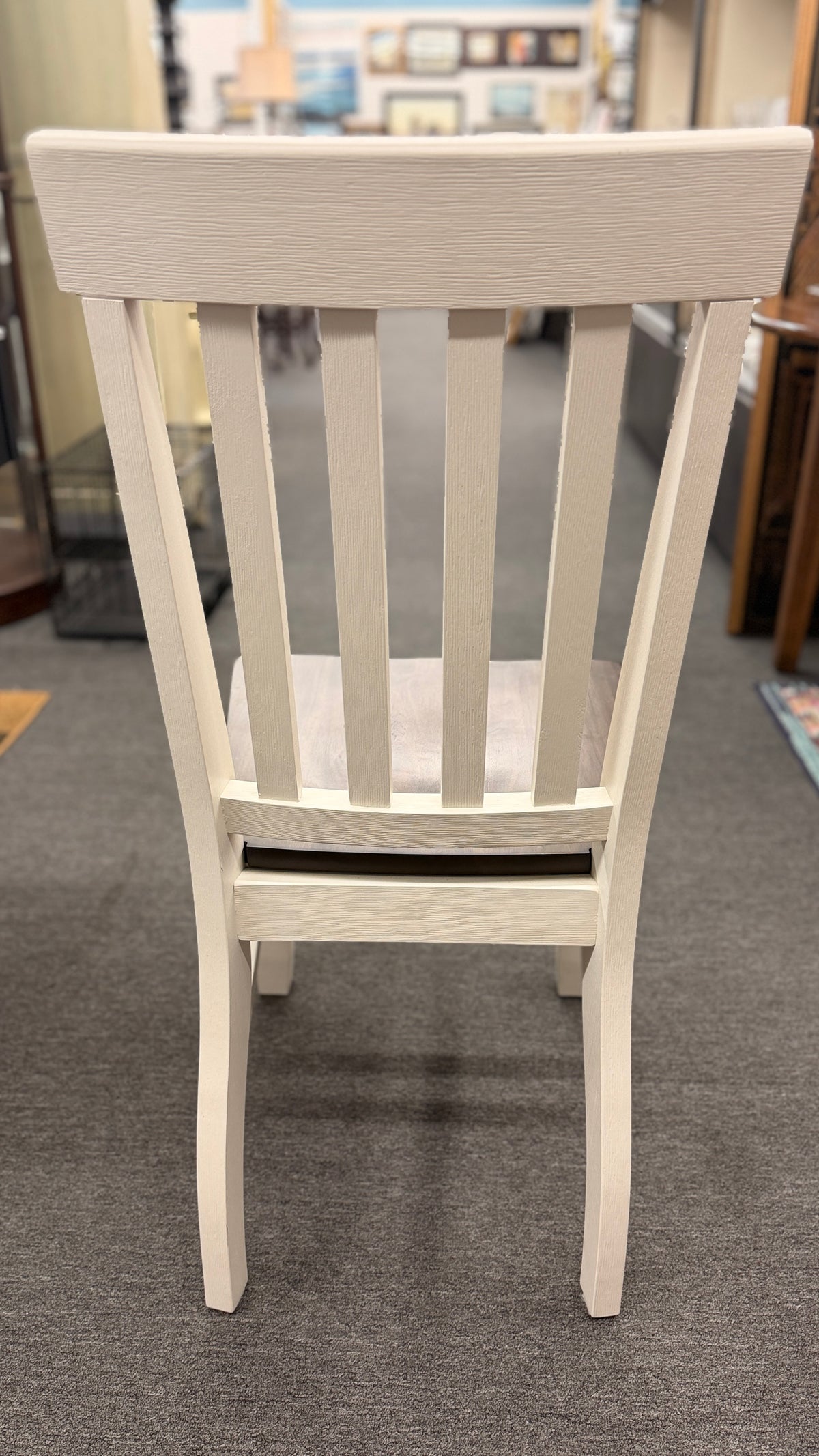 A farmhouse-style rectangular dining set with a dark-stained wood table top, antique white base, and four matching white slat-back chairs in excellent condition.