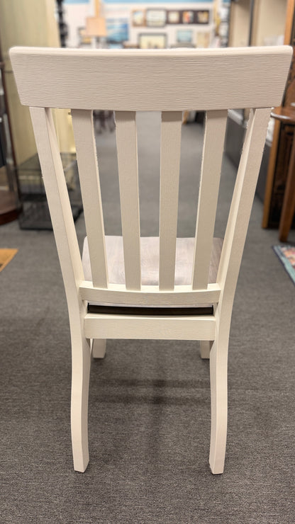 A farmhouse-style rectangular dining set with a dark-stained wood table top, antique white base, and four matching white slat-back chairs in excellent condition.