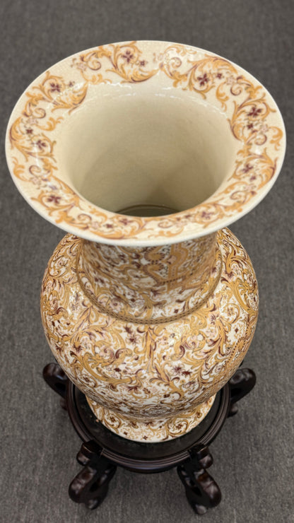 Traditional gold and brown filigree ceramic floor vase with intricate decorative patterns on a curved wood stand at 2nd Debut Houston consignment showroom