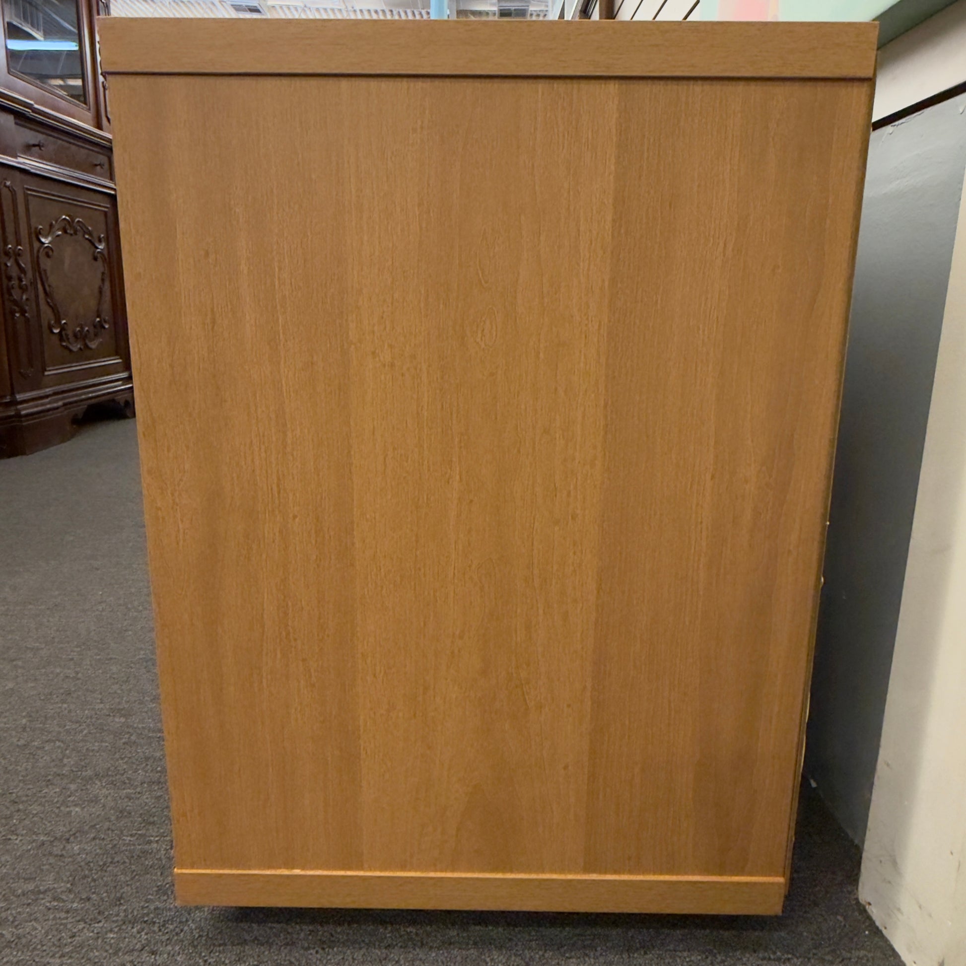 A low-profile minimalist TV stand cabinet featuring textured tambour-style vertical fluted sliding doors in good condition.