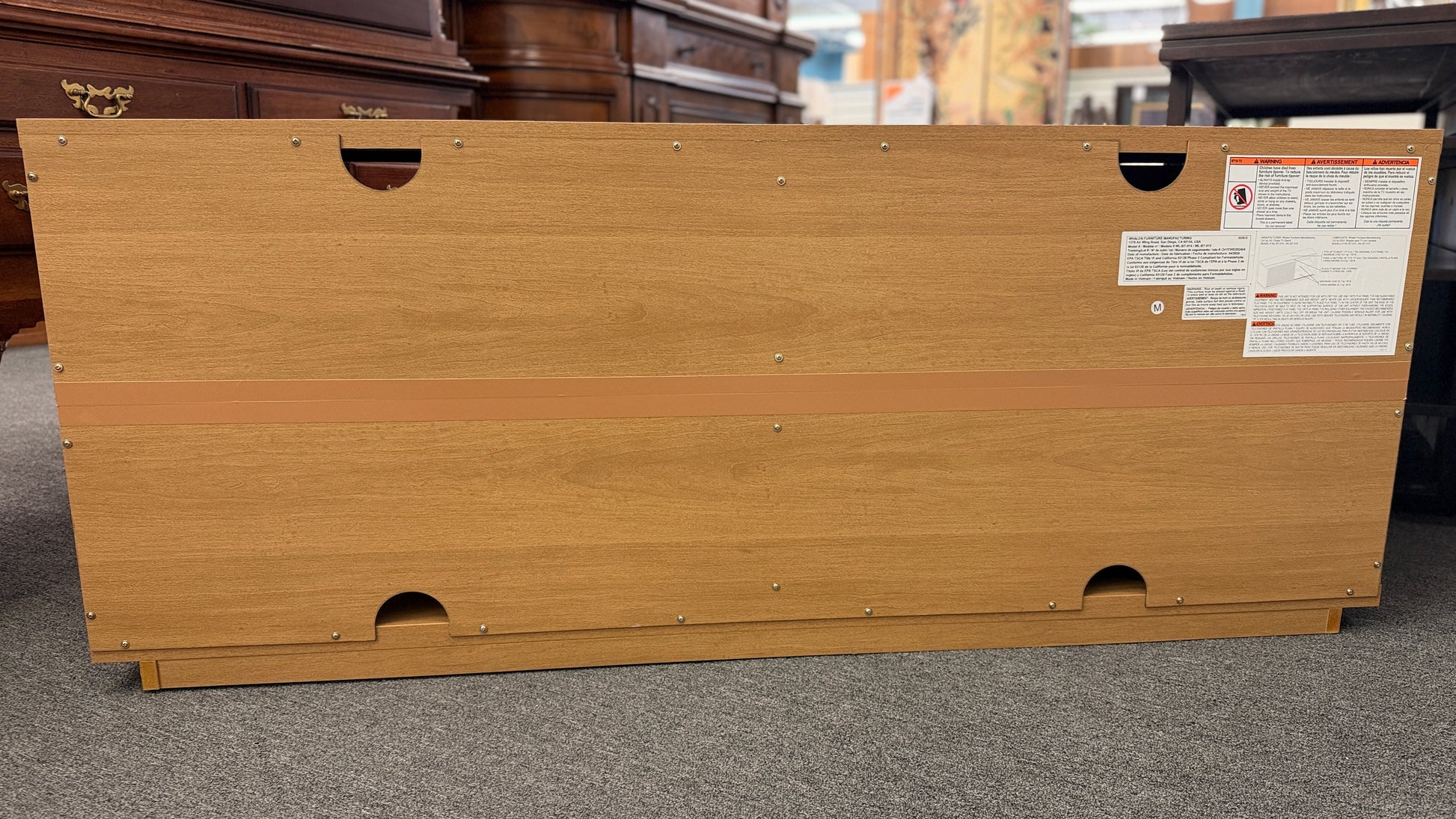 A low-profile minimalist TV stand cabinet featuring textured tambour-style vertical fluted sliding doors in good condition.