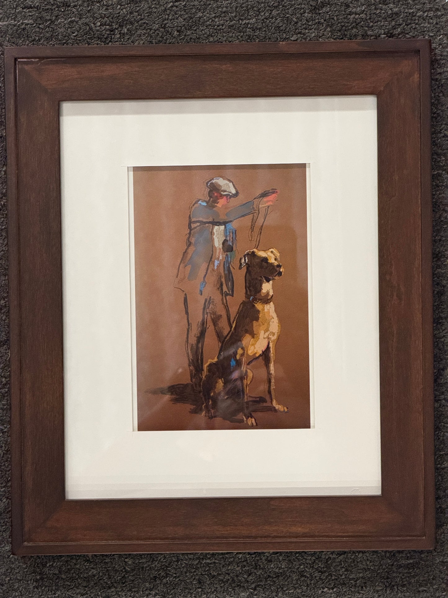 A framed print depicting a handler wearing a flat cap next to a seated Great Dane, featuring a wide white mat and dark wood frame in excellent condition.