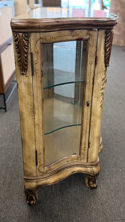 A French Provincial style three-door curio cabinet featuring a distressed antique cream finish, curved glass panels, and carved cabriole feet in excellent condition.
