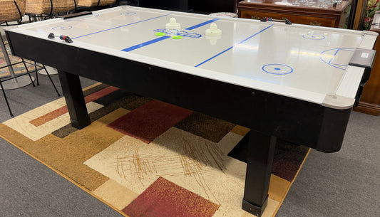 Full-size air hockey table with a white playing surface, blue boundary lines, sturdy black frame, and durable legs for home game room entertainment.