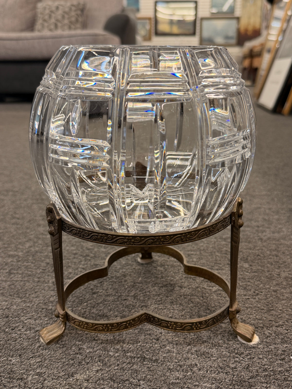A geometric cut-crystal bowl set on an ornate antique brass-finished tripod stand in excellent condition.
