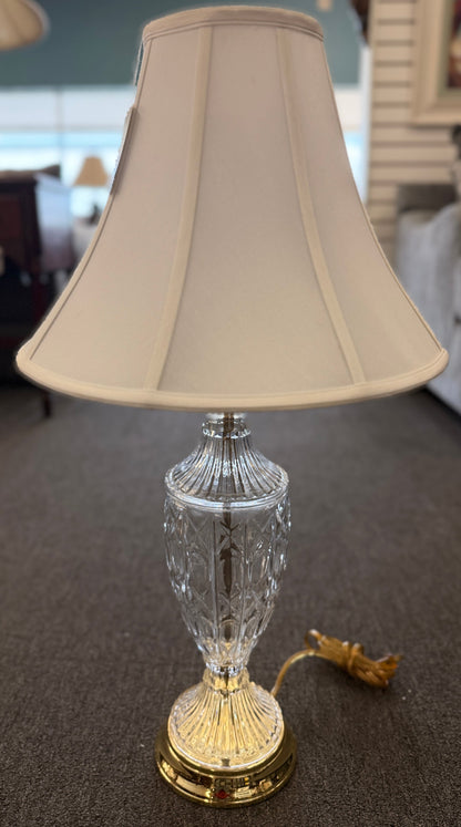 A traditional 29-inch table lamp featuring a diamond-cut crystal urn-shaped body, a polished gold base, and a classic white flared fabric lampshade.