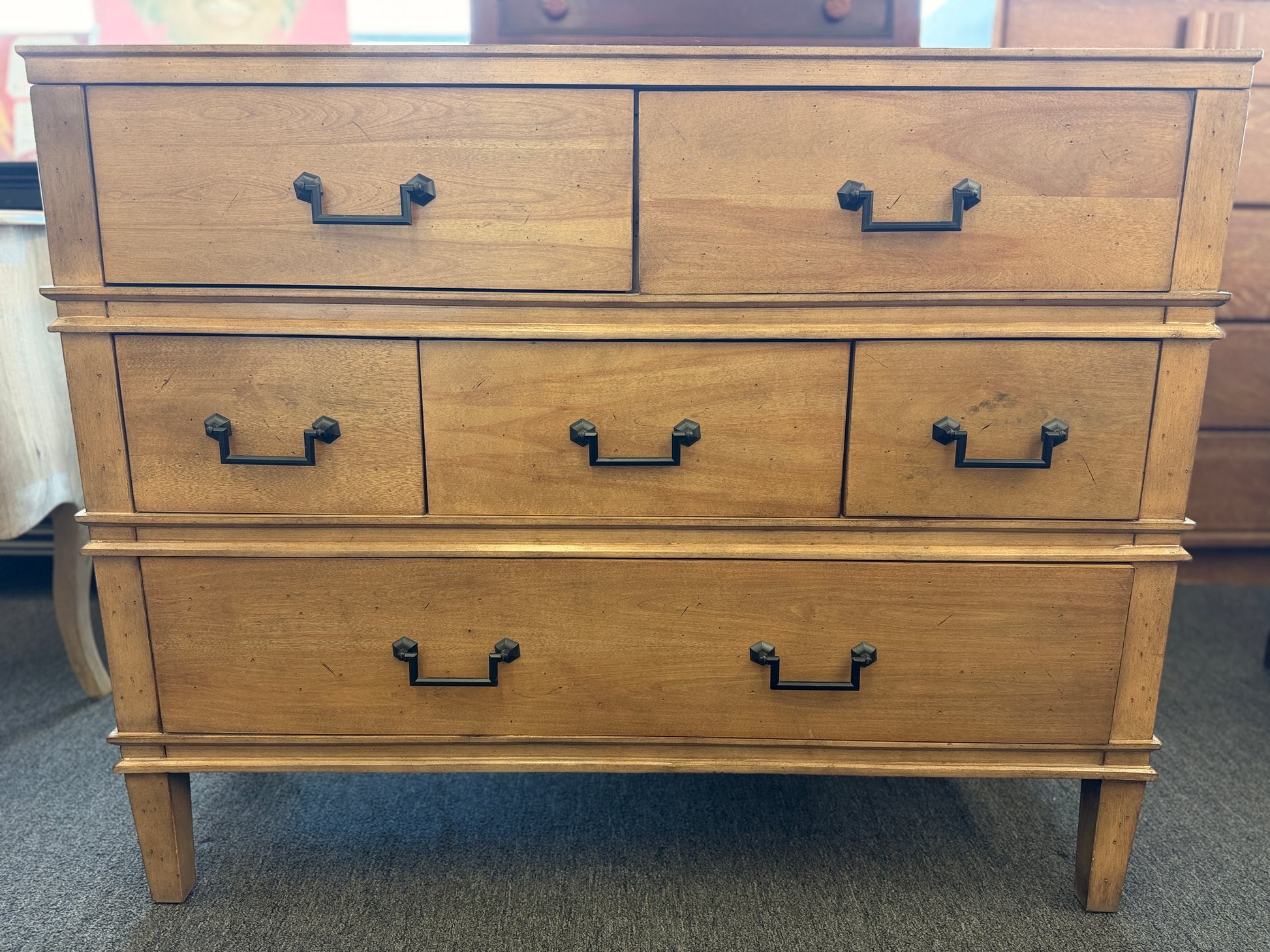Traditional golden brown wood 6 drawer dresser featuring a unique multi tier layout and drop handles at 2nd Debut Houston consignment showroom