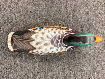 A hand-painted decorative wooden mallard duck decoy featuring detailed feather patterning and glass eyes in excellent condition.