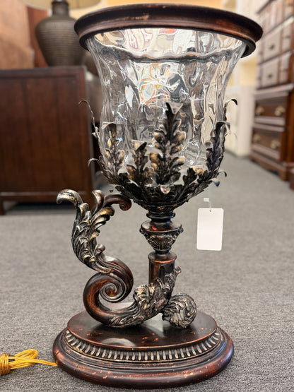 A decorative table lamp constructed from iron, ceramic, and glass in excellent condition.