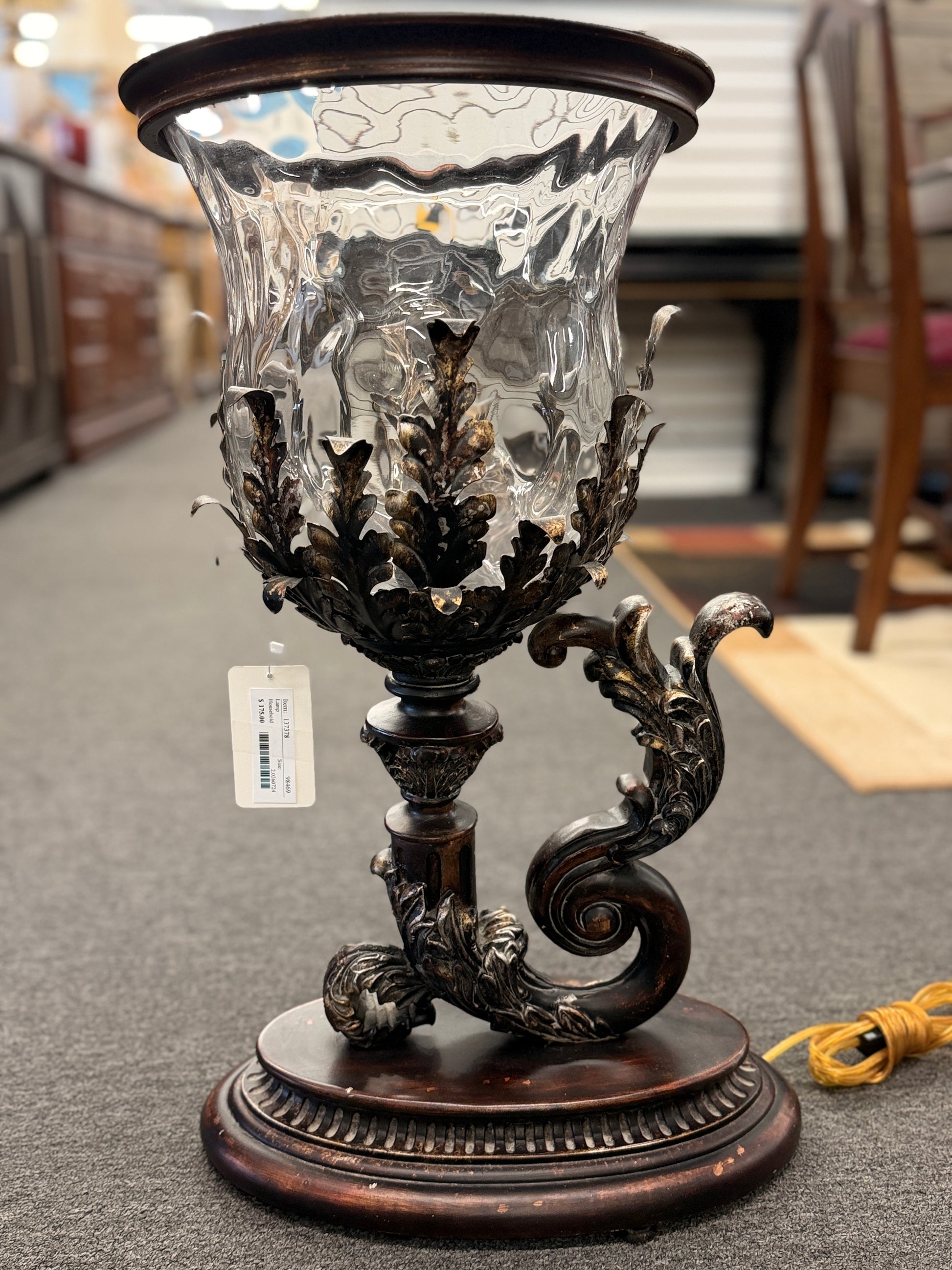 A decorative table lamp constructed from iron, ceramic, and glass in excellent condition.