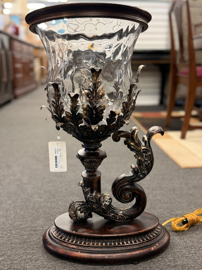 A decorative table lamp constructed from iron, ceramic, and glass in excellent condition.