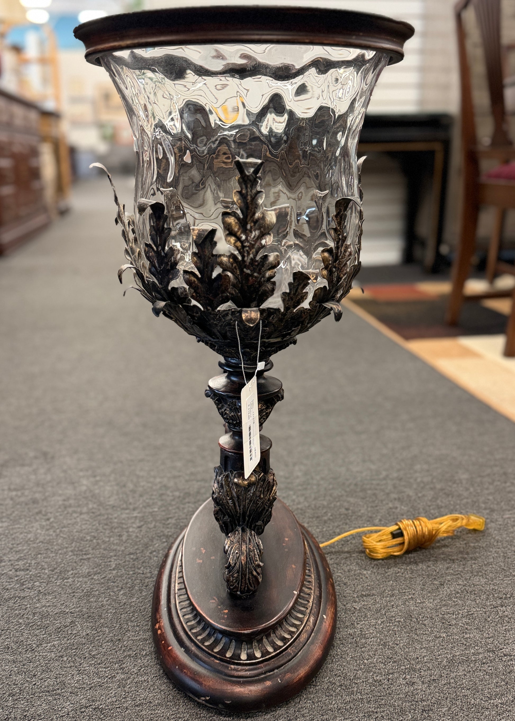 A decorative table lamp constructed from iron, ceramic, and glass in excellent condition.